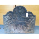 An 18th century style cast iron fireback, 20th century relief cast with lion, tudric rose and