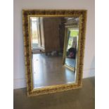 An ornate gilt mirror, 103cm x 75cm