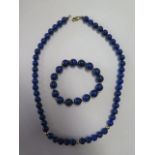 A lapis lazuli and 9ct gold necklace, 45cm long, and bracelet beads approx 6mm on necklace and