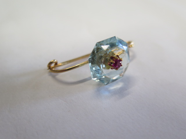 A French 18ct gold brooch with a Ruby set into a light blue hexagonal cut stone, possibly an - Image 2 of 4