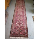 A hand knotted woollen Karajeh, 3.05m x 0.75m, in good condition