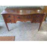 An Edwardian mahogany serpentine fronted sideboard with two cupboards and a single drawer, 76cm tall