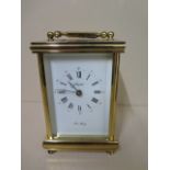 A good quality brass carriage clock by John Morley striking on a bell, 15cm tall with handle down,