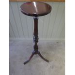 A 20th century fluted and turned tripod plant stand in good polished condition