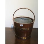 A brass bound oak bucket planter, 45cm x 33cm diameter, in good condition