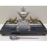 An Empire style gilt and silvered metal desk stand raised on a marble plinth with twin sphinx