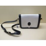 A Cartier white and black ladies leather shoulder bag, 21cm wide, some usage wear and marks and some