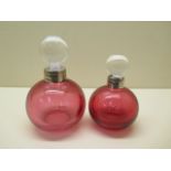 Two Cranberry glass scent bottles with silver rims, tallest 14cm, both good condition