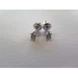 A pair of 14ct white gold diamond stud earrings with screw backs, each approx 0.10ct, in good