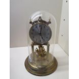 A brass 400 day clock under glass dome, 30cm tall