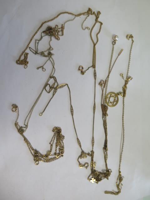 A collection of assorted 9ct gold chains and pendants, some broken and tangled, total weight