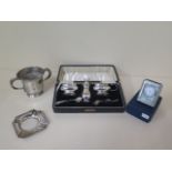 A boxed silver cruet set, a twin handled silver cup, a silver ashtray and a silver mounted quartz