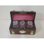 A burr walnut Victorian dome top perfume casket with ormolu mounts containing three scent bottles,