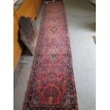 A hand knotted woollen Sarough rug, 3.9m x .80m in good condition