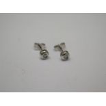 A pair of 9ct white gold and diamond stud earrings, each approx 0.06ct