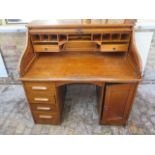 A 1930s oak rolltop twin pedestal four drawer desk with fitted interior, 117cm tall x 122cm wide x