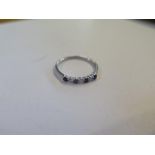 A hallmarked white gold diamond and sapphire seven stone ring, size J, approx 0.8 grams, in good