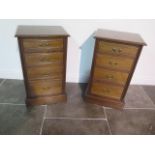 A pair of late Victorian or Edwardian walnut bedside chests each with four graduated drawers with