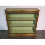 A burr oak open bookcase with a painted interior and two adjustable shelves, made by a local