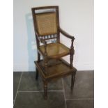 A Victorian oak child's high chair on stand with Bergere cane seat and back, chair detaches from