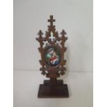 A Victorian carved Black Forest carved icon with a hand painted Vienna porcelain plaque of the