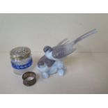A silver top bottle and a silver napkin ring and a Lladro bird group, bottle has a chip to base