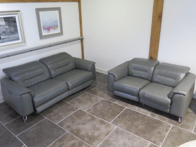 Two Furniture Village soft grey leather seater sofas with electric adjustable head and foot rests