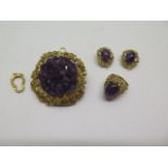 A hallmarked 9ct yellow gold cabouchon amethyst Harris and Maisey ring and earring set, with a