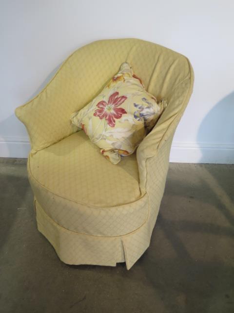 An Edwardian upholstered bedroom chair with a yellow loose cover, generally good, one replacement