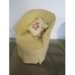 An Edwardian upholstered bedroom chair with a yellow loose cover, generally good, one replacement