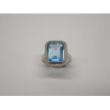 A 9ct hallmarked white gold Art Deco style blue topaz and diamond ring, size M, head approx 16mm x