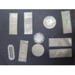 A collection of nine 19th century Chinese mother of pearl gaming tokens and a buckle, all