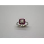 A quality platinum Art Deco style ruby and diamond ring, with diamond shoulders, centre diamond