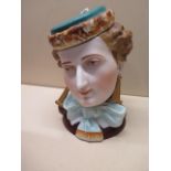 A porcelain pot modelled as a ladies head, 19cm tall, some minor wear but generally good