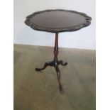 A carved beechwood tilt top wine table with repairs, 59cm tall x 45cm wide