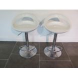 A pair of gas lift bar stools with moulded seats, some usage marks but working