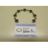 A GTV coin set 9ct yellow gold green sapphire and diamond bracelet, 21cm long, gold weight 17.42