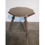 A 19th century walnut octagonal top cricket table on turned legs, 62cm tall x 61 cm