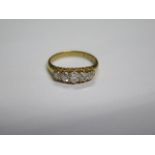 A hallmarked 18ct yellow gold diamond 5 stone ring, size O/P, the central diamond approx 0.23ct,