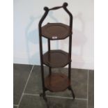A mahogany three tier folding cake stand with octagonal shelves, 88cm tall, very clean condition