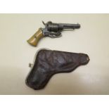 An ealry 1800s 0.54 pin fire revolver purse pistol, 13cm long, with leather purse, cocks and