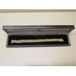 An 18ct trigold woven bracelet, 20cm long, approx 37 grams, marked 750, generally good with minor