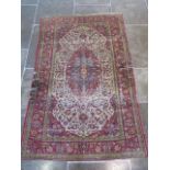 A worn but decorative machine woven rug, 200cm x 128cm