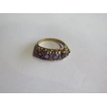 A 9ct hallmarked yellow gold amethyst five stone ring, size P, approx 3.9 grams, in generally good