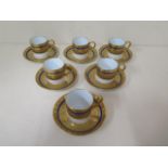 A set of six gilt and blue Limoges coffee cans and saucers, all in good condition