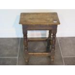 An 18th century oak joint stool, 57cm tall x 45cm x 27cm, with wear consistent with age and later