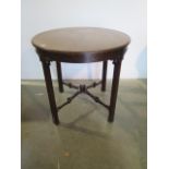 An Edwardian mahogany circular window table with a carved frieze and fretted stretchers, 71cm tall x
