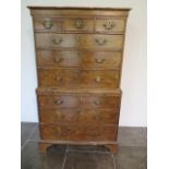 A George 1st walnut chest on chest with three small drawers, over a brushing slide and three further