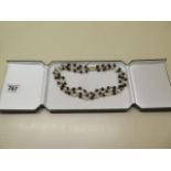 A tiger eye, pearl and gold bead three strand necklace with a 9ct gold clasp, 38cm long, in good