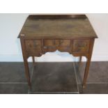 A Georgian walnut lowboy with three oak lined drawers on square tapering legs, 76cm tall including